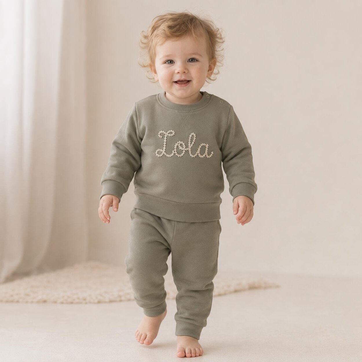 Child wearing personalised khaki sweatshirt and joggers
