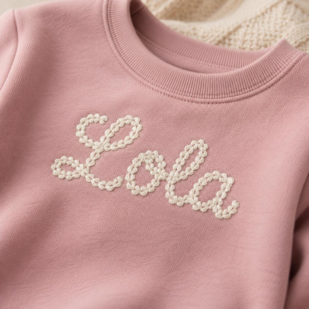 Close-up of chain stitch-style name embroidery