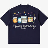 Printora UK navy blue heavyweight cotton t-shirt featuring a cute cartoon school lunch graphic and Serving Smiles Daily
