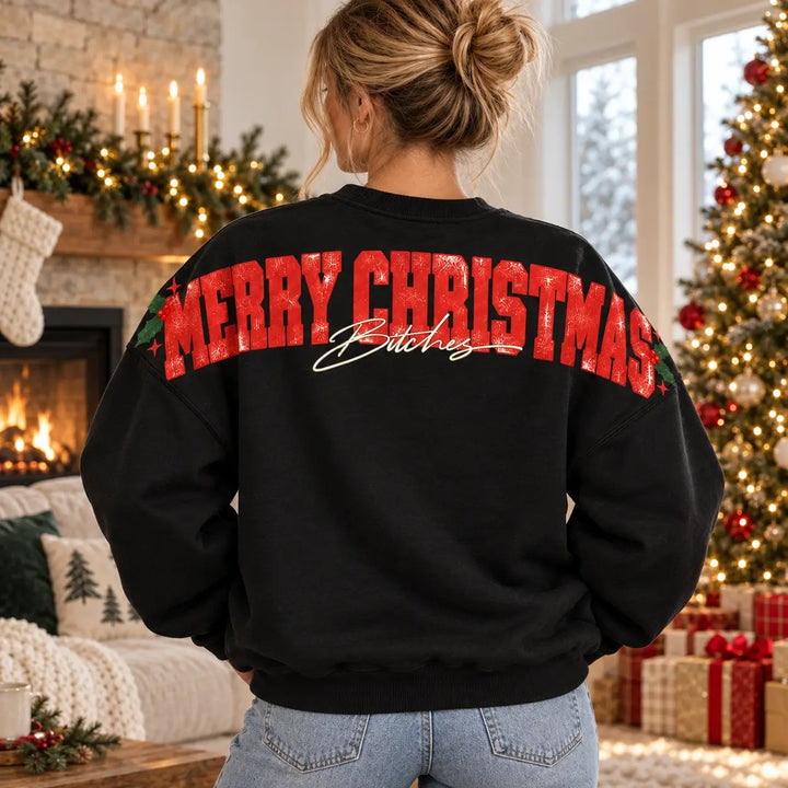 Woman modelling black unisex Merry Christmas Bitches jumper from behind, bold red upper-back and sleeve lettering