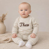 Personalised baby tracksuit in light stone worn by baby