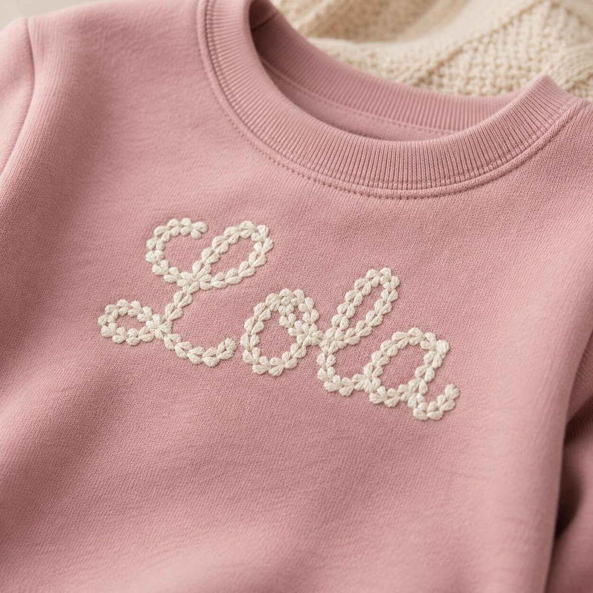 Close-up of chain stitch-style name embroidery