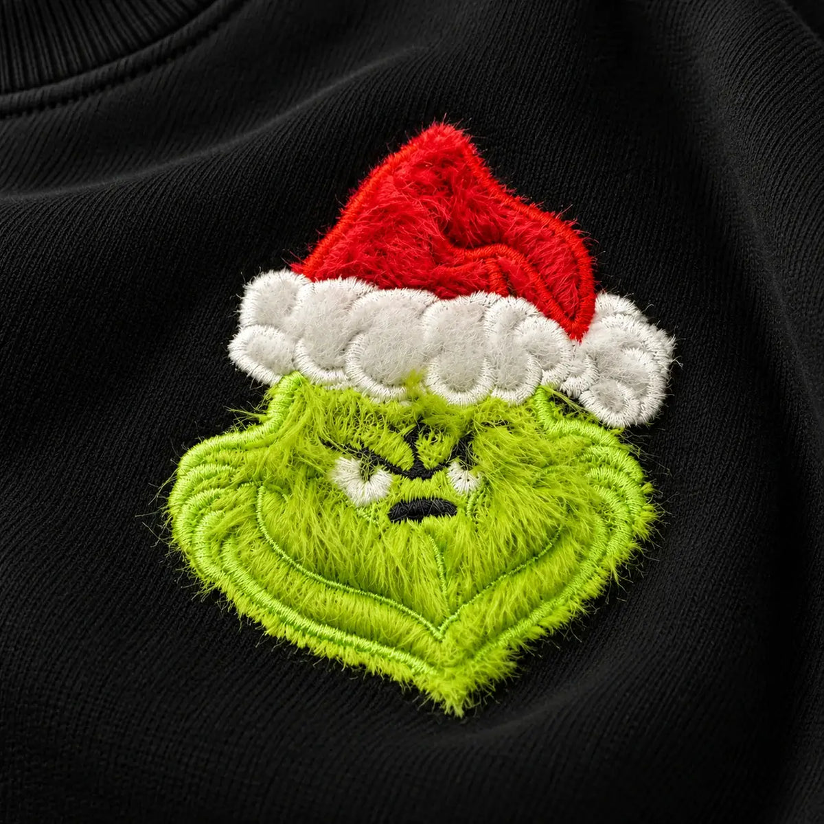 Christmas jumper Embroidery Closeup: optional fluffy festive green Santa-hat chest embroidery and large lime Hate Hate Hate Loathe Entirely back print, Printora UK