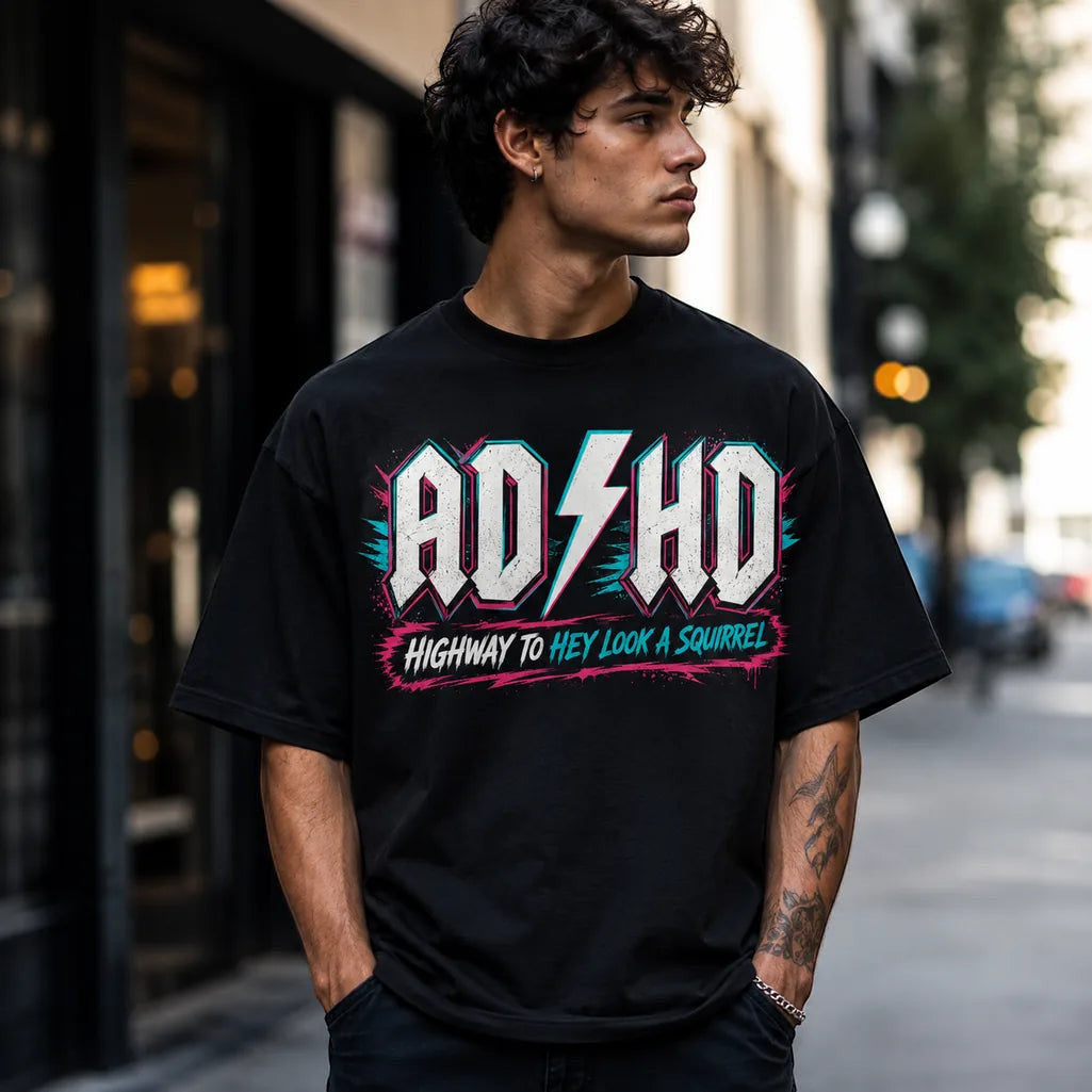 Printora UK black unisex cotton t-shirt with neon ADHD Highway to Hey Look a Squirrel graphic worn by a young man