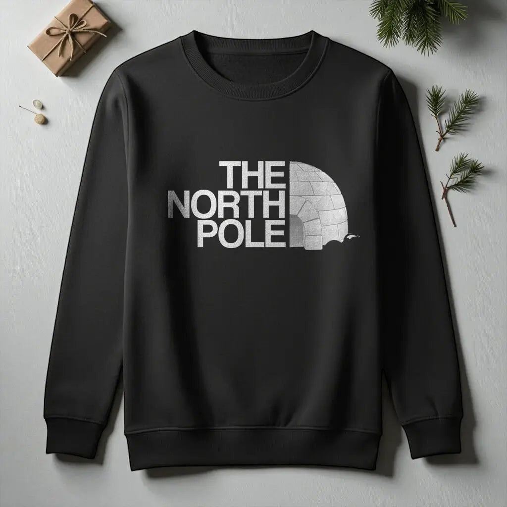 Printora UK black crew neck Christmas jumper featuring a white The North Pole igloo graphic print on the chest.