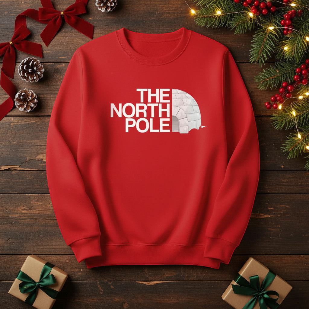 Printora UK red crew neck Christmas jumper featuring a white The North Pole igloo logo graphic on a festive background