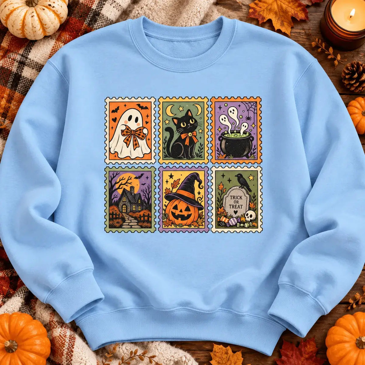 Sky blue vintage Halloween postage stamp jumper autumn flat lay